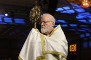 Boston Cardinal Sean P. O’Malley carries a monstrance during eucharistic adoration.