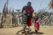 A mother helps her malnourished son stand after he collapsed near their hut in the village of Lomoputh in northern Kenya, on May 12, 2022. United Nations Under-Secretary-General for Humanitarian Affairs Martin Griffiths visited the area on Thursday to see the effects of the drought which the U.N. says is a severe climate-induced humanitarian emergency in the Horn of Africa. (AP Photo/Brian Inganga)