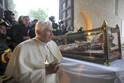 Pope Benedict XVI views the casket of St. Celestine V, a 13th-century pope who resigned, during his visit to the earthquake-damaged Basilica of Santa Maria di Collemaggio in L'Aquila, Italy, in this April 28, 2009, file photo. Pope Benedict retired in 2013. (CNS photo/L'Osservatore Romano via Reuters)