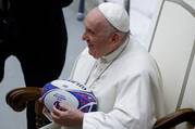 for an article on sports conference at the vatican, pope francis holds a rugby ball while smiling