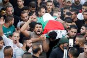 People carry the body of 12-year-old Mahmoud Samoudi during his funeral in the Israeli-occupied West Bank, Oct. 10, 2022.