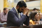 A man prays after receiving Communion during Mass at Sacred Heart of Jesus Church in New York City Oct. 11, 2022. The service preceded a eucharistic procession through Midtown Manhattan to St. Patrick's Cathedral, where New York Cardinal Timothy M. Dolan led Benediction. (CNS photo/Gregory A. Shemitz)