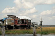 A statue of Mary stands alongside a hurricane-damaged house on the coast of southern Louisiana (photo: Kevin Jackson/America Media).