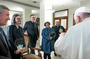 america staff stands and listens to the pope who is to the right of the camera