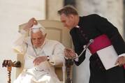 Pope Benedict XVI replaces his zucchetto after a wind gust as his personal secretary, Msgr. Georg Ganswein, assists during the pontiff's general audience in St. Peter's Square at the Vatican in this Oct. 27, 2010 file photo. Archbishop Gänswein has written a book about his life with the late pope and his own difficult relationship with Pope Francis. (CNS photo/Paul Haring)