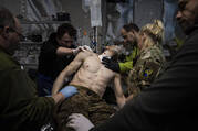 Ukrainian military medics treat their wounded comrade at the field hospital near Bakhmut, Ukraine, Sunday, Feb. 26, 2023. (AP Photo/Evgeniy Maloletka)