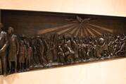 a bas relief sculpture of black people from slavery to emancipation with holy spirit above them