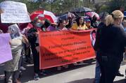 Several honduran women hold a large red sign calling for justice for Ana Lizeth Hernández