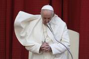 an image of pope francis standing with hands closed in prayer against a red background