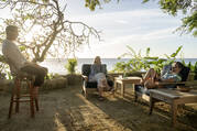 Three actors from the HBO show Succession sitting in a patio overlooking the ocean