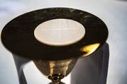 The Eucharist rests on a paten at the altar in the Cathedral of St. Peter in Wilmington, Del., May 27, 2021.