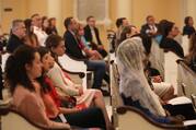 people sit in a church at the catholic media conference