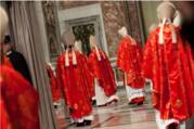 Several cardinals, in red, enter St. Peter's basilica