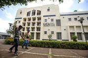 Workers walk past a building of the Jesuit-run Central American University in Managua, Nicaragua, on Aug. 16, 2023. The university suspended operations Aug. 16 after Nicaraguan authorities branded the school a "center of terrorism" the previous day and froze its assets for confiscation. (OSV News photo/Reuters)