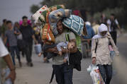 Palestinians flee to the southern Gaza Strip on Salah al-Din Street in Bureij, Gaza Strip, Saturday, Nov. 11, 2023. (AP Photo/Fatima Shbair)