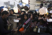 Palestinians line up for food in Rafah, Gaza Strip, on March 12. (AP Photo/Fatima Shbair)