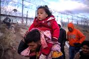 Briana, a 1-year-old migrant girl from Peru, is carried by her father, Jordan, as they search for an entry point into the United States past a razor wire-laden fence along the bank of the Rio Grande in El Paso, Texas, March 26, 2024. (OSV News photo/Adrees Latif, Reuters)