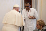 Pope Francis greets Agbonkhianmeghe Orobator, S.J., and Julie Sullivan, the president of Santa Clara University, on March 18, 2024. 