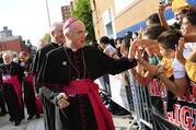 Archbishop Carlo Maria Viganò, then-apostolic nuncio to the United States, greets children during Pope Francis' visit to Our Lady Queen of Angels School in East Harlem, New York, in this Sept. 25, 2015, file photo (CNS photo/Eric Thayer/The New York Times, pool).