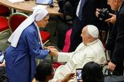 Pope Francis greets a religious woman before the start of the opening working session of the Synod of Bishops