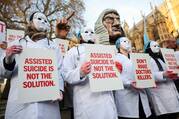 Protestors stand outside Parliament as British lawmakers debate an assisted dying law in London on Nov. 29, 2024. (OSV News photo/Mina Kim, Reuters)