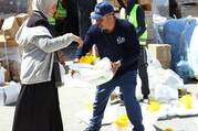 A Catholic Relief Services worker distributes shelter material to a woman in Rafah, in the southern Gaza Strip, March 21, 2024, displaced by the ongoing conflict between Israel and Hamas. (OSV News photo/Mohammad Al Hout for CRS)