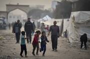Displaced Palestinian children run past tents at the Islamic University of Gaza compound amid the ongoing war in Gaza, Sunday, April 6, 2025. (AP Photo/Jehad Alshrafi)