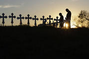 Isaac Hernandez and his wife Crystal visit a line of crosses before a vigil for the victims of the First Baptist Church shooting, Monday, Nov. 6, 2017, in Sutherland Springs, Texas. (AP Photo/David J. Phillip)