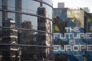 The glass front of a building which houses the translators of the European Commission in Brussels on March 20, 2018. (AP Photo/Virginia Mayo)