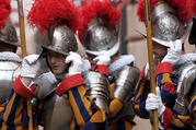In this May 6, 2008 file photo, new Vatican Swiss Guards adjust their helmets prior to a swearing-in ceremony at the Vatican. The world’s oldest standing army is getting some new headgear. The Swiss Guards plan to replace their metal helmets with plastic PVC ones made with a 3-D printer, giving the pope's army cooler and more comfortable headgear when standing guard for hours at a time. (AP Photo/Alessandra Tarantino, pool)