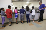 Detained immigrant children line up in the cafeteria in this Sept. 10, 2014 file photo at the Karnes County Residential Center, a detention center for immigrant families operated by the GEO Group in Karnes City, Texas. (AP Photo/Eric Gay, File)