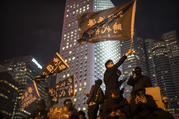 A protestor holds a flag that reads: "Liberate Hong Kong, Revolution of Our Times" at a rally in Hong Kong on Dec. 12. Protesters wrote hundreds of Christmas cards for detainees jailed during the city's pro-democracy movement. (AP Photo/Mark Schiefelbein)