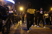 Protesters walk past a line of police in downtown Columbus, Ohio, on Thursday during a demonstration over the death of George Floyd in police custody Monday in Minneapolis. (Barbara J. Perenic/The Columbus Dispatch via AP)