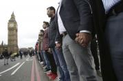Londoners link hands during a commemorative event to mark last week's attack outside Parliament on Westminster Bridge on March 29. (Yui Mok/PA via AP)