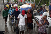 People cross a bridge over a rushing river as part of evacuations during Hurricane Matthew Oct. 4, 2016 in Port-au-Prince, Haiti (CNS photo/Orlando Barria, EPA).