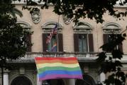 Rainbow flags fly alongside the U.S. flag outside the U.S. Embassy to Italy in Rome June 16. A prayer service was held nearby at St. Patrick's Catholic Church in remembrance of the victims of the Orlando, Fla., terrorist attack (CNS photo/Paul Haring).