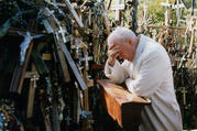 Pope John Paul II prays in 1993 at the Hill of Crosses in Siauliai, Lithuania. Pope Francis will make the same three-nation visit, stopping at a number of the same places as his saint-predecessor. (CNS photo/Arturo Mari, L'Osservatore Romano) 