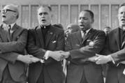 Rev. Dr. Martin Luther King Jr. with The University of Notre Dame President Rev. Theodore M. Hesburgh, C.S.C., Rev. Edgar Chandler (far left), and Msgr. Robert J. Hagarty of Chicago (far right) at the Illinois Rally for Civil Rights in Chicago's Soldier Field, 1964. (The University of Notre Dame Archives)