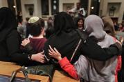 In this Thursday, Feb. 16, 2017 photo, members of the Sisterhood Salaam Shalom, gather for a group photo after a unity vigil held at the Jewish Theological Seminary in New York. (AP Photo/Julie Jacobson)