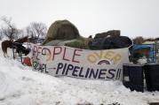 Hay is stacked up to feed horses at a protest encampment along the route of the Dakota Access oil pipeline near Cannon Ball in southern North Dakota on Tuesday, Jan. 24, 2017. President Donald Trump on Tuesday issued an executive action to advance construction of the pipeline, which opponents believe threatens drinking water and cultural sites. The pipeline developer disputes that. (AP Photo/James MacPherson)