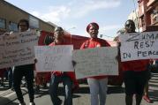 At a May Day rally in Bloemfontein, South Africa, trade unionists demand that South African President Jacob Zuma step down. The president was jeered by labor activists and his speech was cancelled after scuffles broke out between his supporters and workers chanting for him to step down at the rally. (AP Photo/Khothatso Mokone)