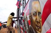 A man boards a matatu minibus adorned with Barack Obama, head of the US president’s visit. Photograph: Simon Maina/AFP/Getty Images