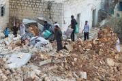 Civilians carry belongings recovered from a site hit by what residents said were airstrikes carried out by the Russian air force in Aleppo, Syria, Oct. 7. (CNS photo/Ammar Abdullah, Reuters)