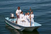 Altar servers from St. Mary of the Assumption at St. Ann's Church in Hull, Mass., approach a pier in August 2013 as part of a festival for the feast of the Assumption of Mary. 