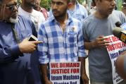 Saif Akonjee, son of Imam Maulana Alauddin Akonjee, center, Mashuk Uddin, brother of Thara Uddin, right, and other members of the community are surrounded by reporters as they arrives to a Queens courthouse in New York, on Aug. 16. (AP Photo/Seth Wenig)