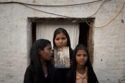 Asia Bibi's daughters hold up a picture of their mother