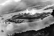 Photograph taken from a Japanese plane during the torpedo attack on ships moored on both sides of Ford Island shortly after the beginning of the Pearl Harbor attack. (Photo from Wikimedia Commons)