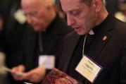 Bishop Frank J. Caggiano of Bridgeport, Conn., reads from booklet during the opening prayer of the annual spring meeting of the U.S. Conference of Catholic Bishops in New Orleans June 11, 2014. (CNS photo/Bob Roller)
