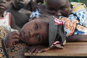 Girl displaced as a result of Boko Haram attack in Nigeria rests her head on desk at camp for displaced people, Jan. 20, 2015 (CNS photo/Afolabi Sotunde, Reuters). 