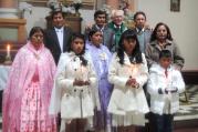 Father Sebastian Obermaier poses for a photo with three children and their families after a baptism in El Alto, Bolivia, July 4. (CNS photo/David Agren) 